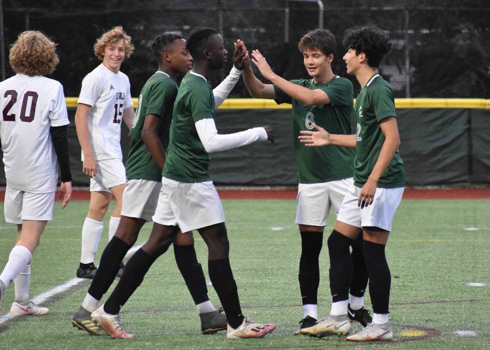 Central boys celebrating a goal together on the field