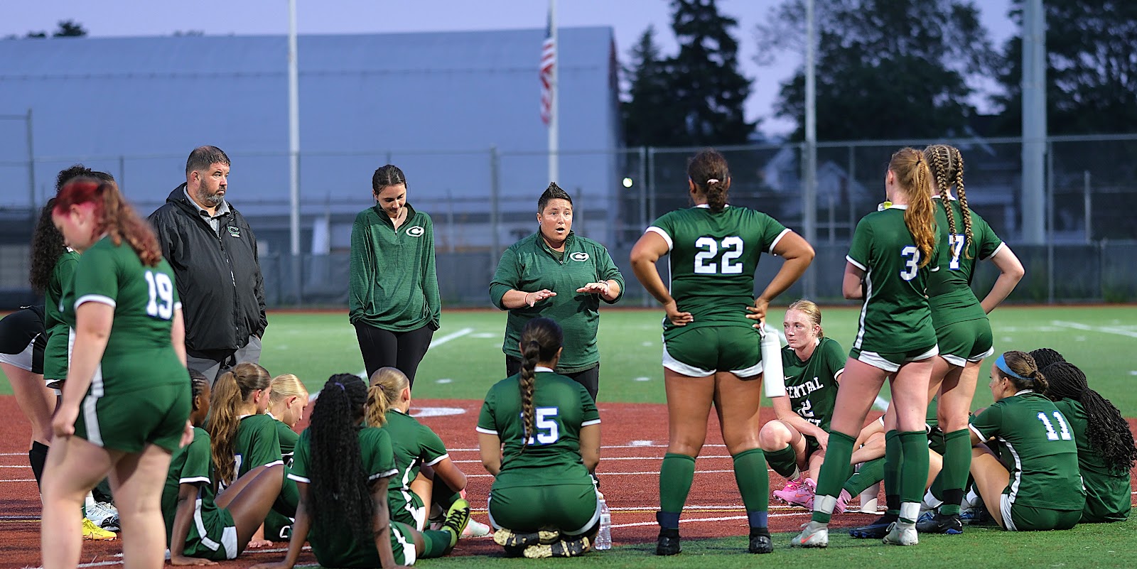 Central West head coach addressing the girls' team on the sideline between halves